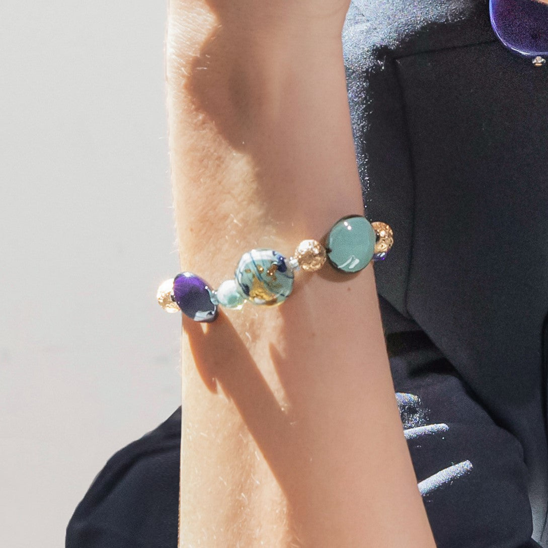 Model wearing MURRINAMURANO Venezia bracelet from the Gaia Collection, handcrafted in Original Murano glass, 18KT Gold Finish or Rhodium finish, over Brass. Made in Italy – murrinamurano.us