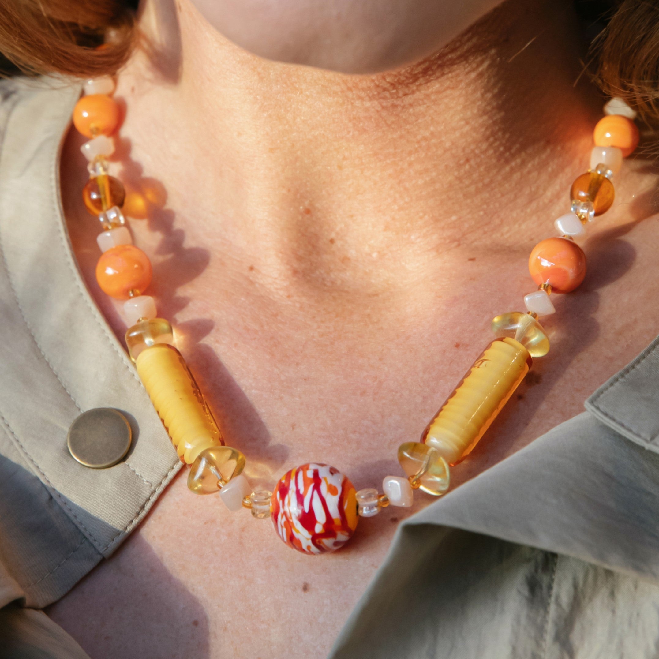 Model wearing MURRINAMURANO Venezia necklace from the Tasnim Collection, handcrafted in Original Murano glass, 18KT Gold Finish or Rhodium finish, over Brass. Made in Italy – murrinamurano.us