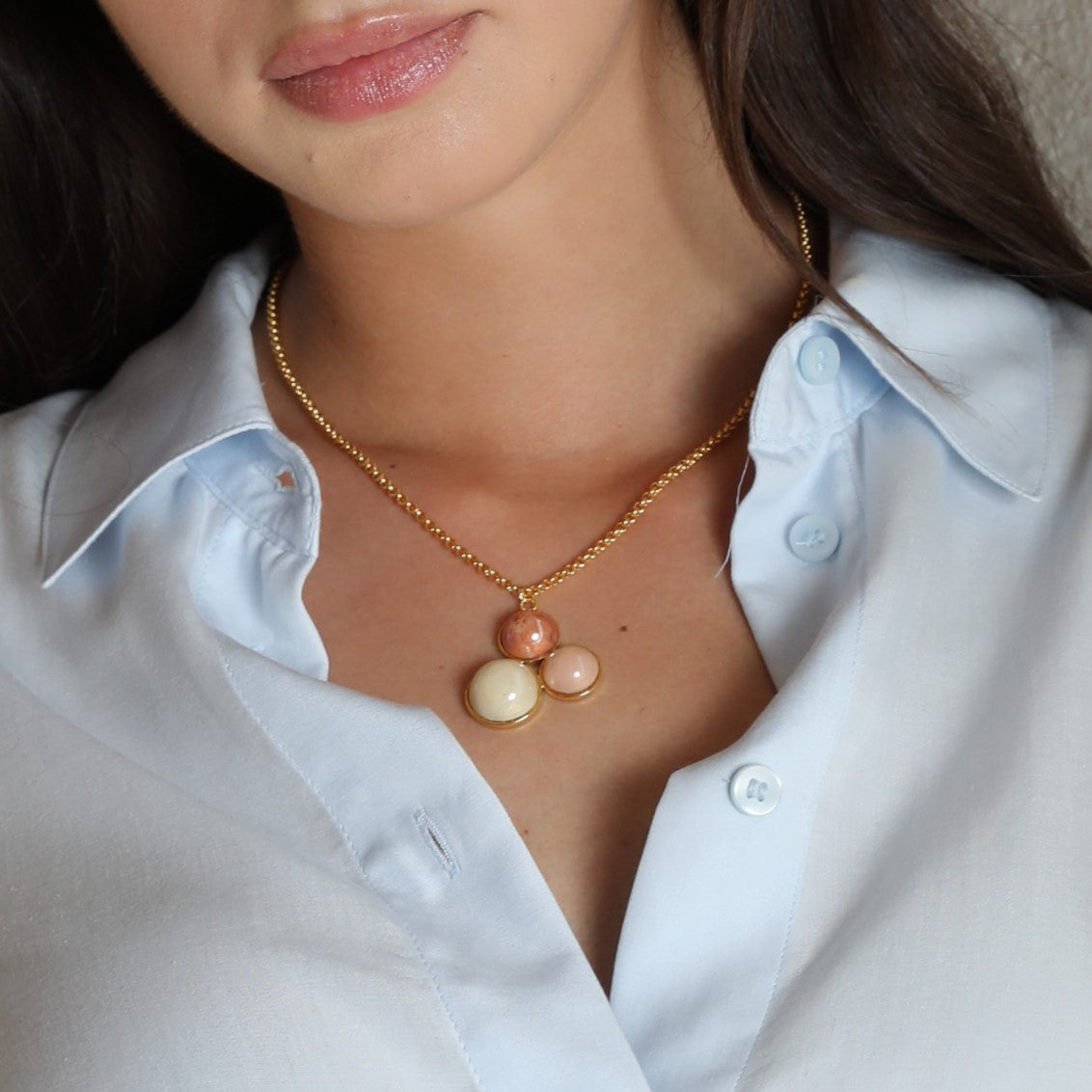 Model wearing MURRINAMURANO Venezia Necklace from the Audrey Collection, handcrafted in Original Murano glass, 18KT Gold Finish or Rhodium finish, over Brass. Made in Italy – murrinamurano.us