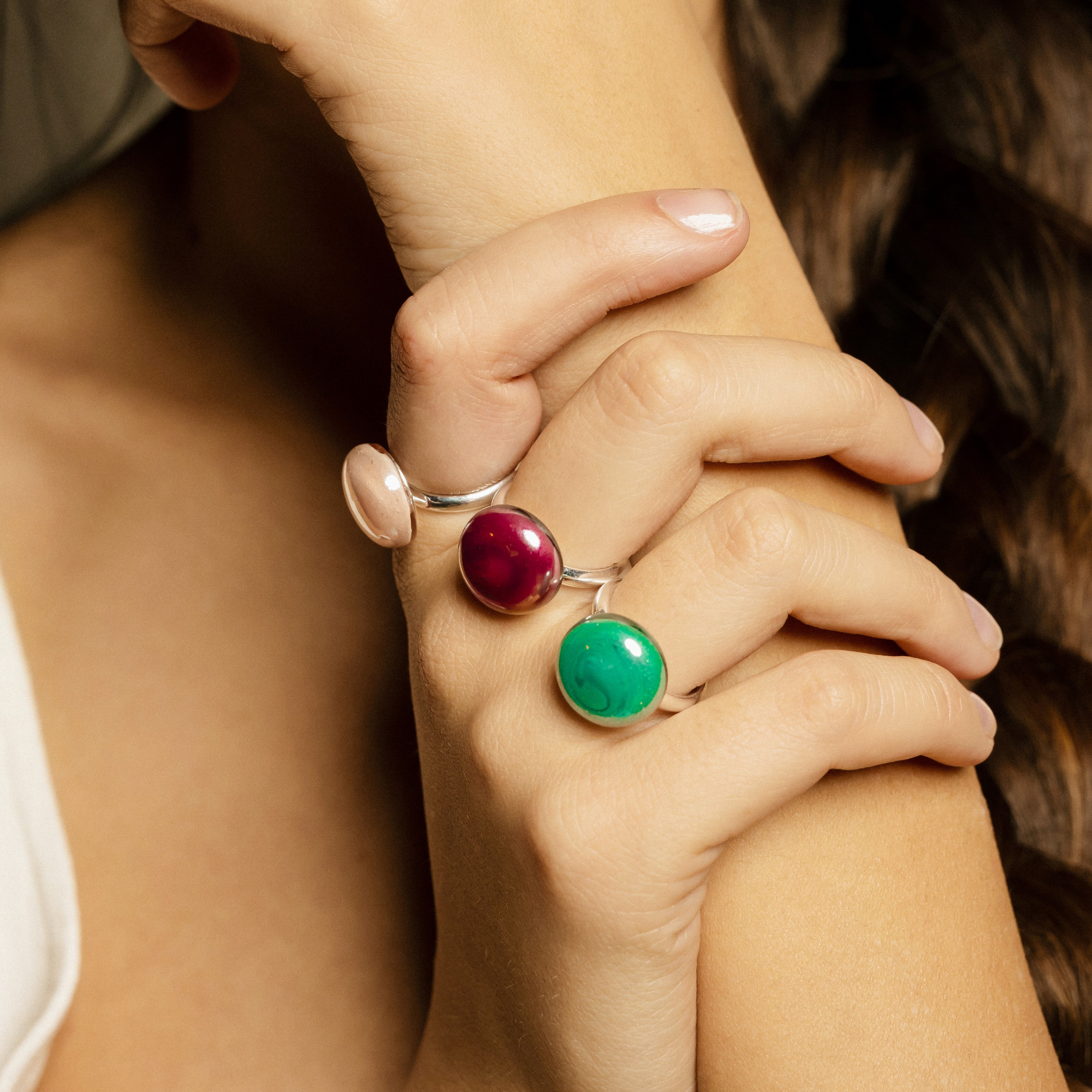 Model wearing MURRINAMURANO Venezia Rings from the Drop Collection, handcrafted in Original Murano glass, 18KT Gold Finish or Rhodium finish, over Brass. Made in Italy – murrinamurano.us