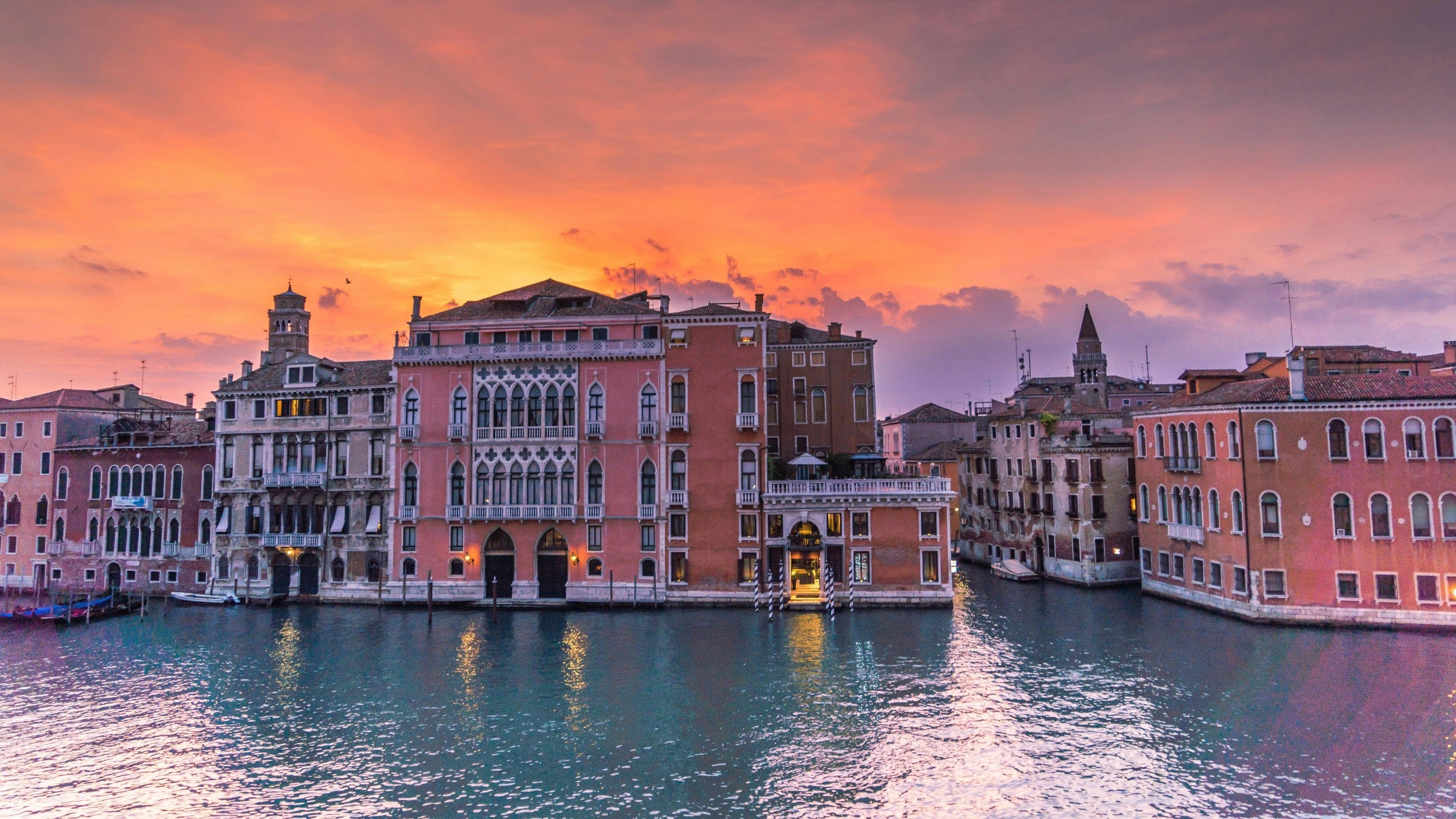 Venice cityscape with buildings along the Grand Canal at sunset.
