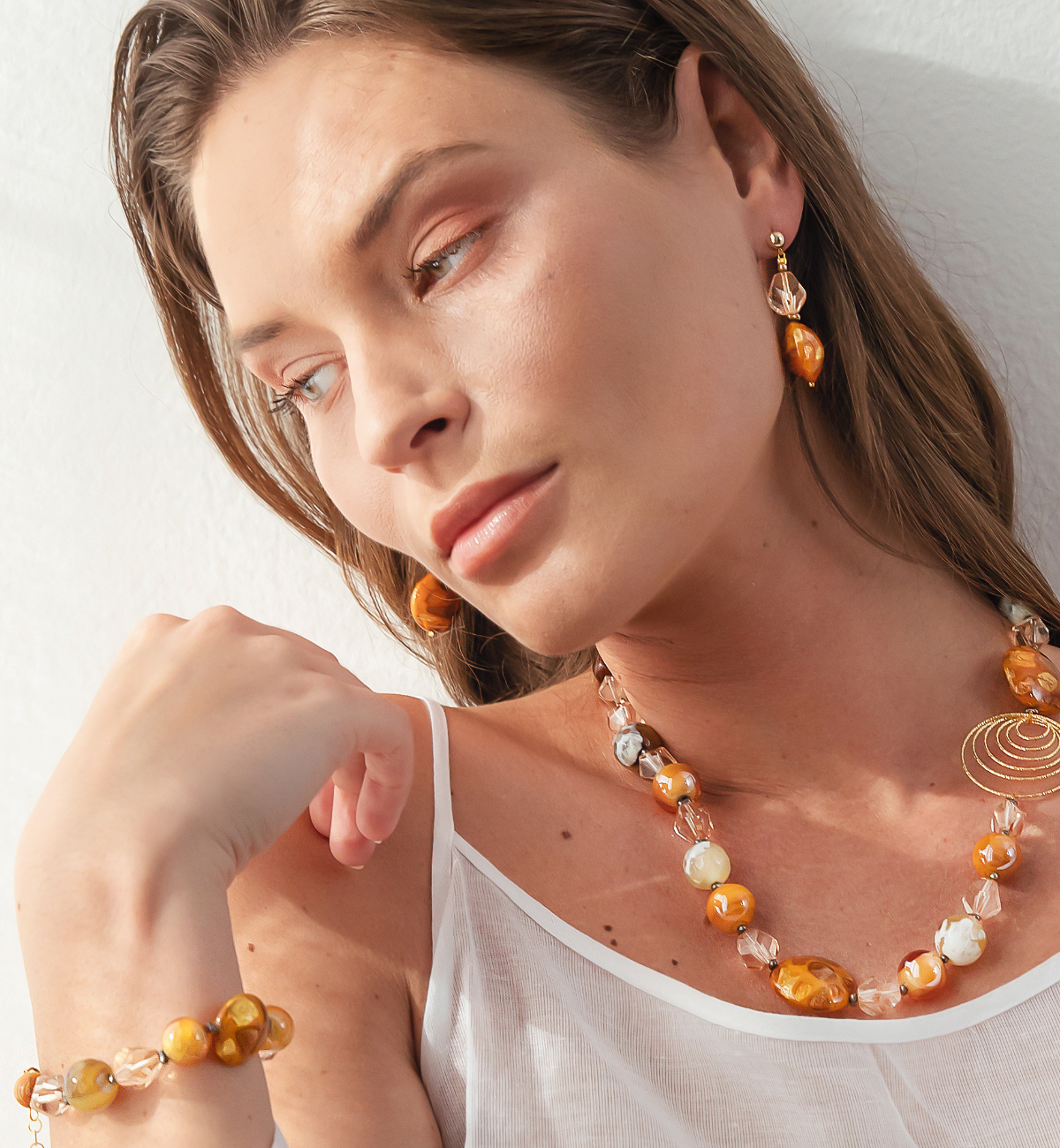 Model wearing MURRINAMURANO Venezia Rings from the Aura  Collection, handcrafted in Original Murano glass, 18KT Gold Finish or Rhodium finish, over Brass. Made in Italy – murrinamurano.us