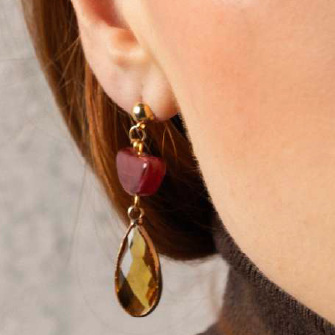 MurrinaMurano.us model wearing Core Top Drop Earrings in red Murano Glass with bright yellow faceted crystal drops, creating a warm contrast of color and light. Handcrafted in Italy.