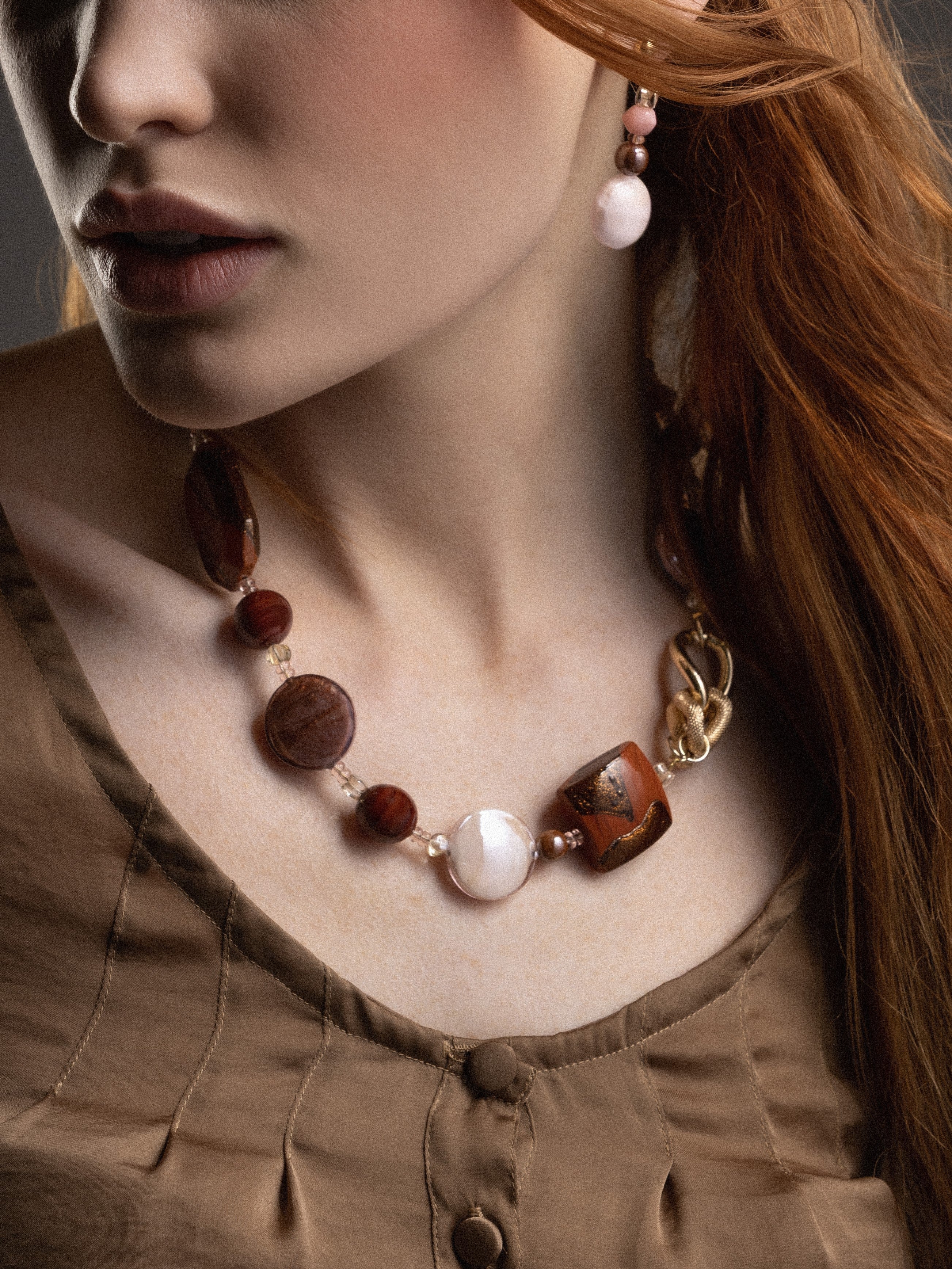 MurrinaMurano.us model wearing Frame earrings in rich brown Murano Glass, with a delicate vertical arrangement of translucent beads and luminous oversized glass drops. Handcrafted in Italy.