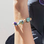 Model wearing MURRINAMURANO Venezia bracelet from the Gaia Collection, handcrafted in Original Murano glass, 18KT Gold Finish  over Brass. Made in Italy – murrinamurano.us