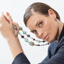 Model wearing MURRINAMURANO Venezia necklace from the Gaia Collection, handcrafted in Original Murano glass, 18KT Gold Finish over Stainless Steel. Made in Italy – murrinamurano.us