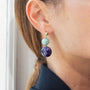 Model wearing MURRINAMURANO Venezia earrings from the Gaia Collection, handcrafted in Original Murano glass, 18KT Gold Finish  over Brass. Made in Italy – murrinamurano.us