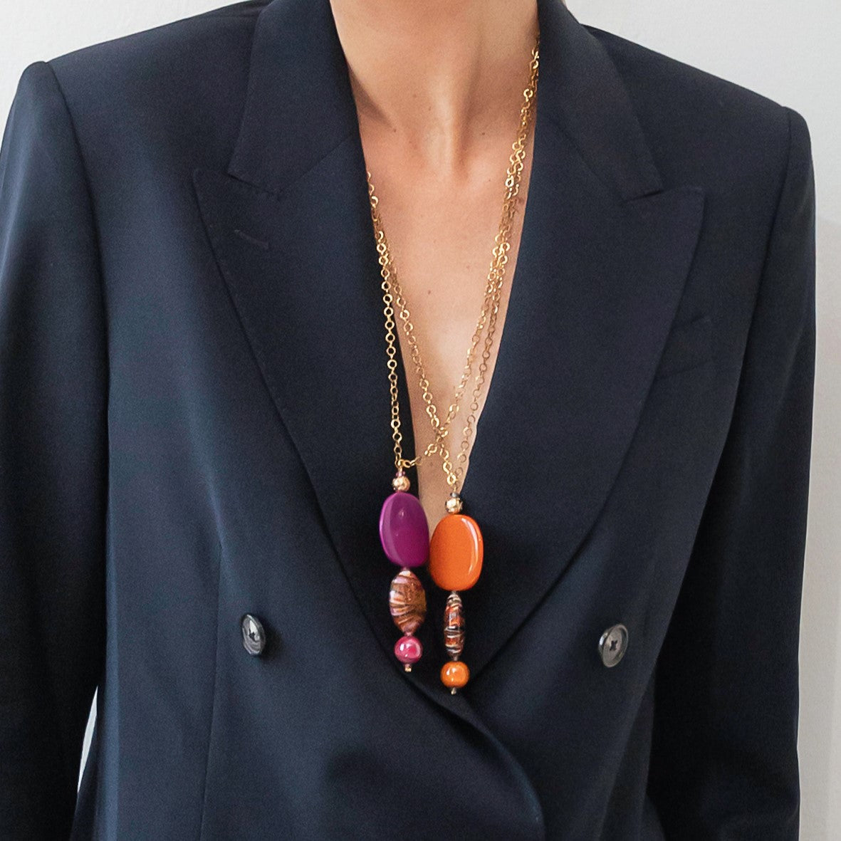 Model wearing MURRINAMURANO Venezia necklace from the Gaia Collection, handcrafted in Original Murano glass, 18KT Gold Finish over Stainless Steel. Made in Italy – murrinamurano.us