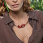Model wearing MURRINAMURANO Venezia necklace and earrings from the Soraya Collection, handcrafted in Original Murano glass, Available in  18KT Gold Finish over brass or Rhodium finish over Brass. Made in Italy – murrinamurano.us