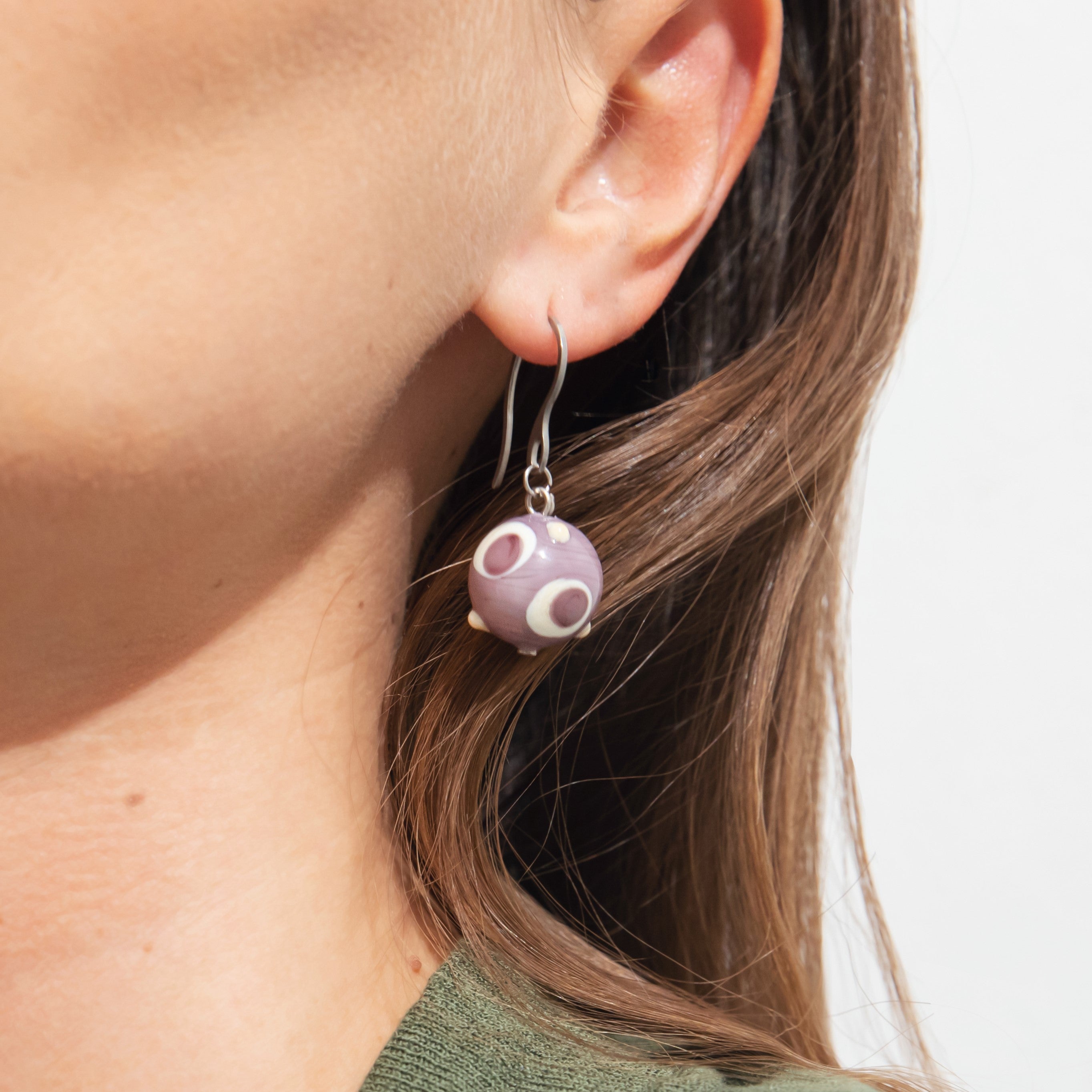 Model wearing MURRINAMURANO Venezia Earrings from the Elettra Collection, handcrafted in Original Murano glass, with Rhodium Finish over Stainless Steel, Made in Italy