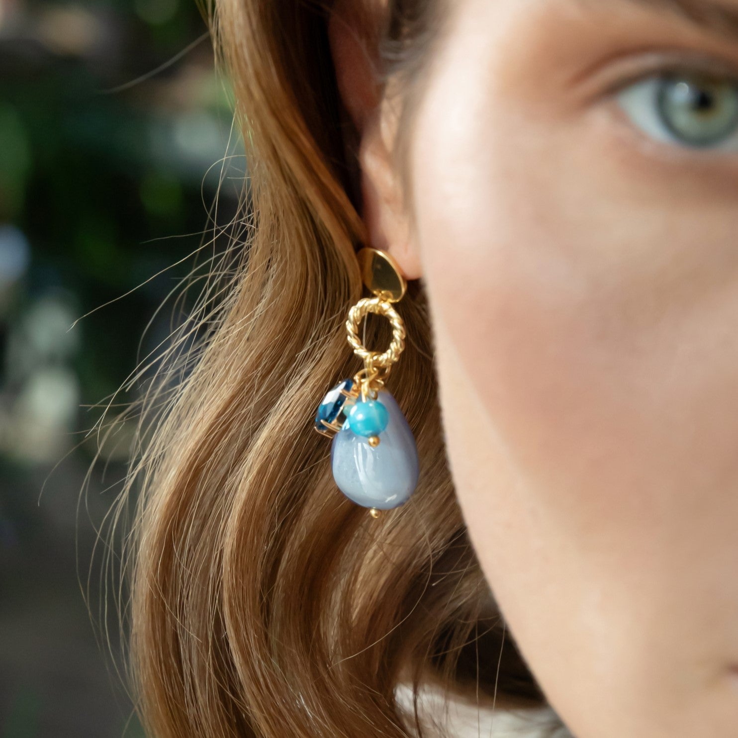 Model wearing MURRINAMURANO Venezia earrings  from the Jasmine Collection, handcrafted in Original Murano glass, 18KT Gold Finish over Brass. Made in Italy – murrinamurano.us