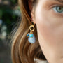 Model wearing MURRINAMURANO Venezia earrings  from the Jasmine Collection, handcrafted in Original Murano glass, 18KT Gold Finish over Brass. Made in Italy – murrinamurano.us