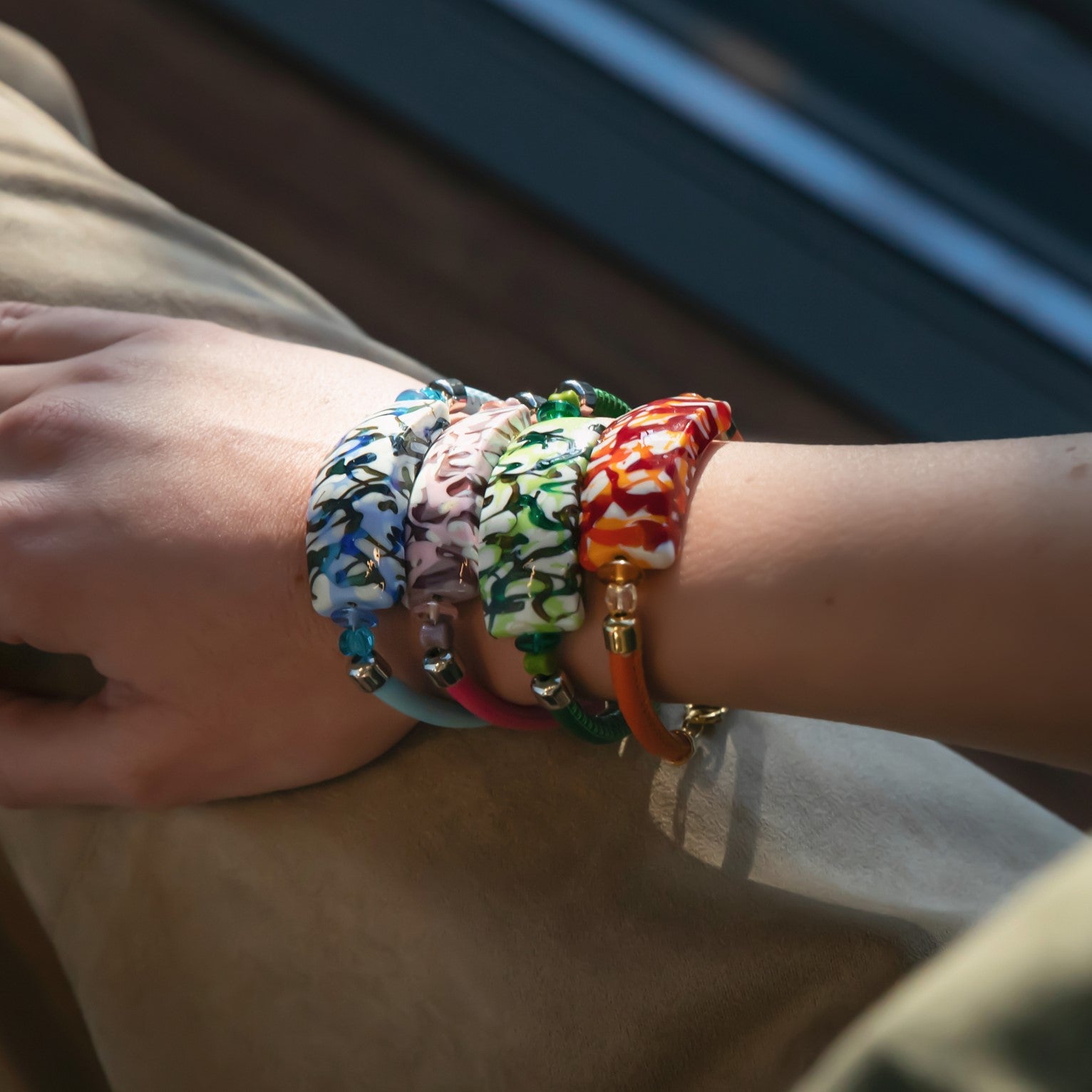 Model wearing MURRINAMURANO Venezia bracelets from the Tasnim Collection, handcrafted in Original Murano glass, available in 18KT Gold Finish or Rhodium finish, over Brass. Made in Italy – murrinamurano.us