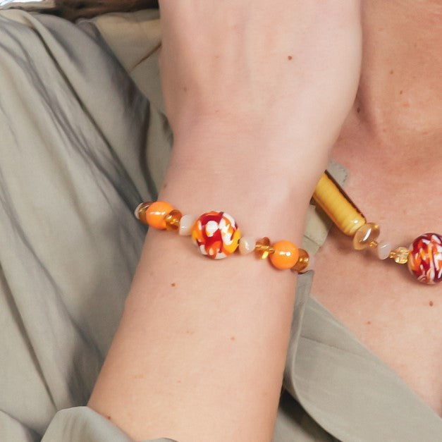 Model wearing MURRINAMURANO Venezia bracelet from the Tasnim Collection, handcrafted in Original Murano glass, Available in 18KT Gold Finish over brass or Rhodium finish over Brass. Made in Italy – murrinamurano.us