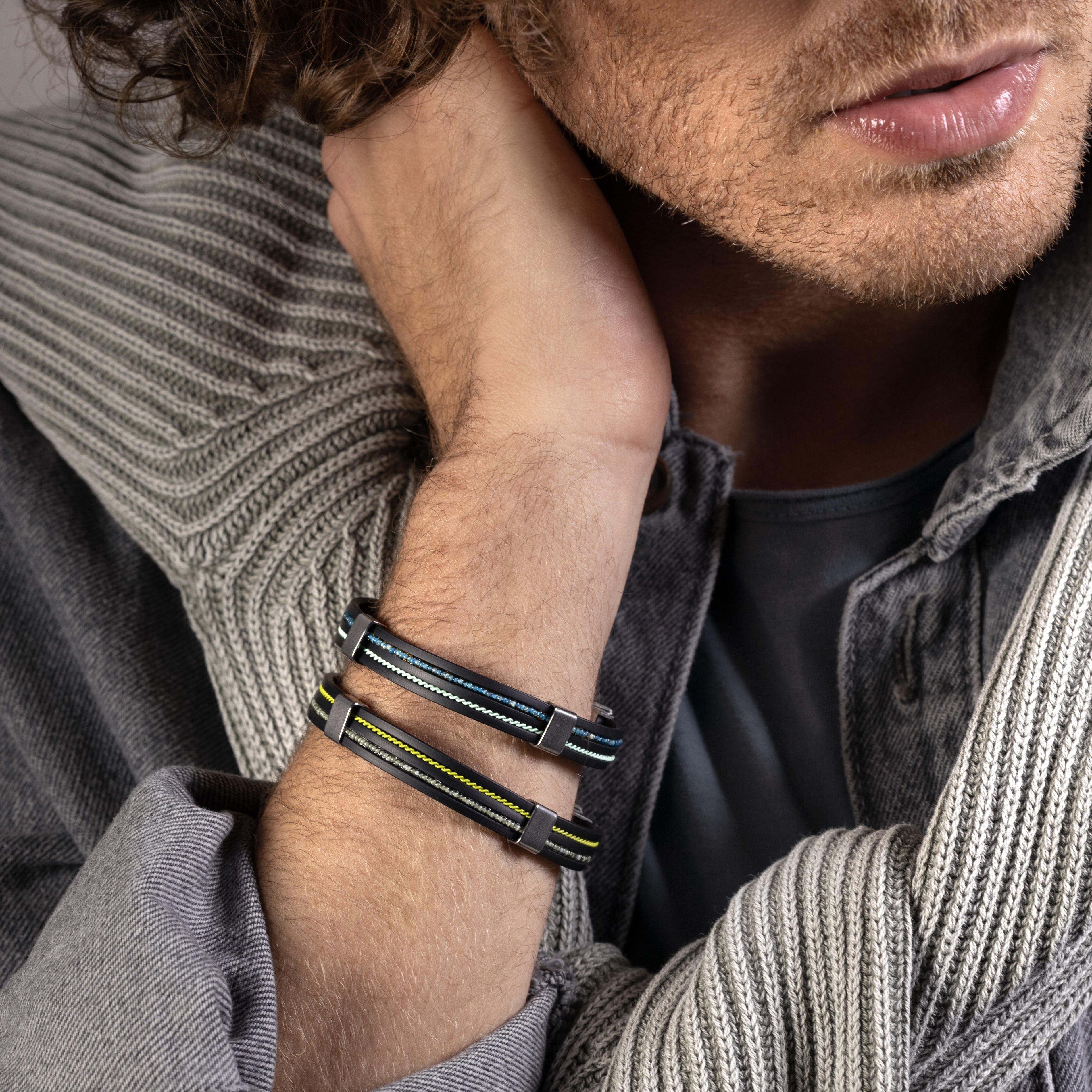 Man wearing a Grain Collection men’s bracelet with steel, glass and rubber, rhodium finish over stainless steel and brass, 20 cm length.