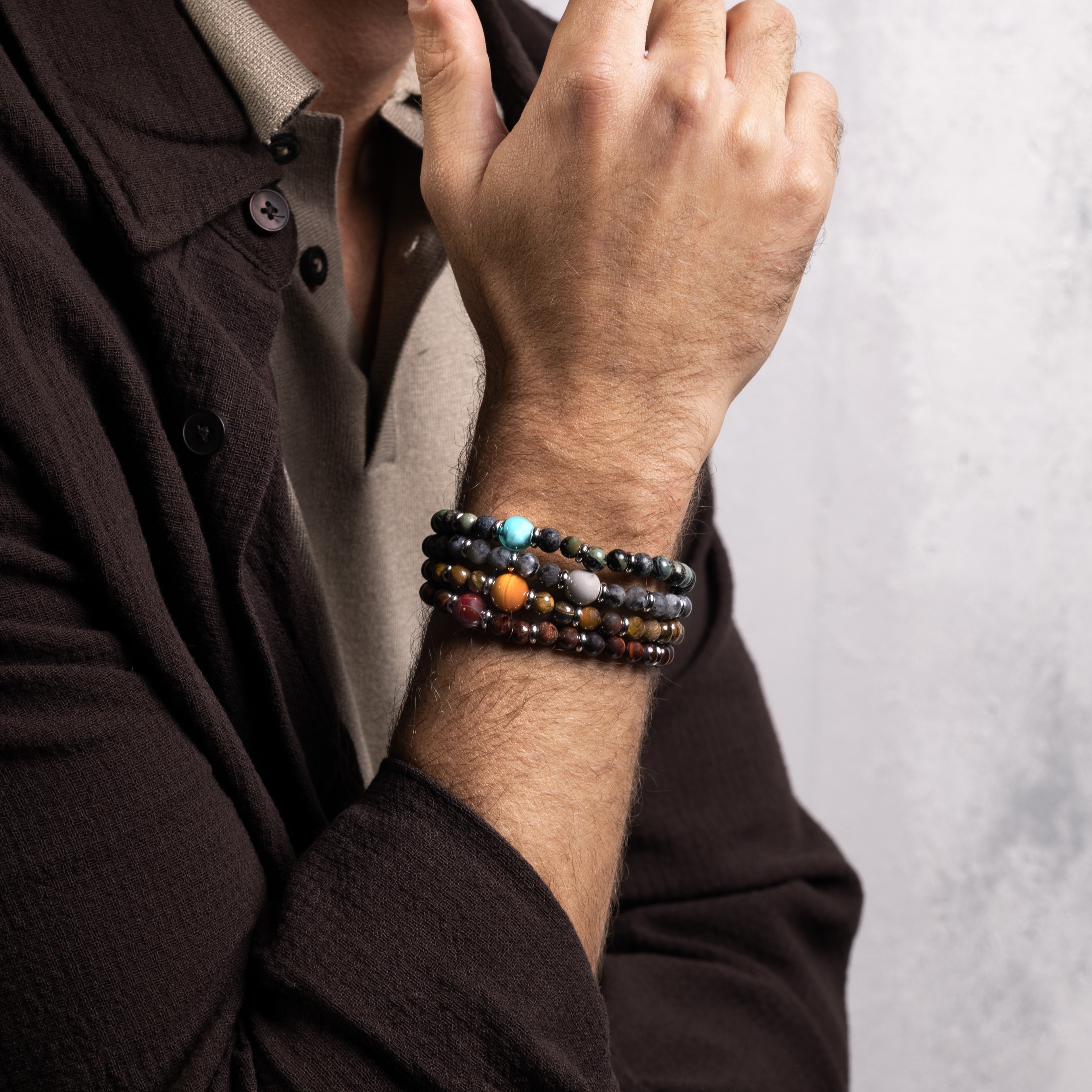 Koko Collection - Person wearing a colorful beaded bracelet on a neutral background