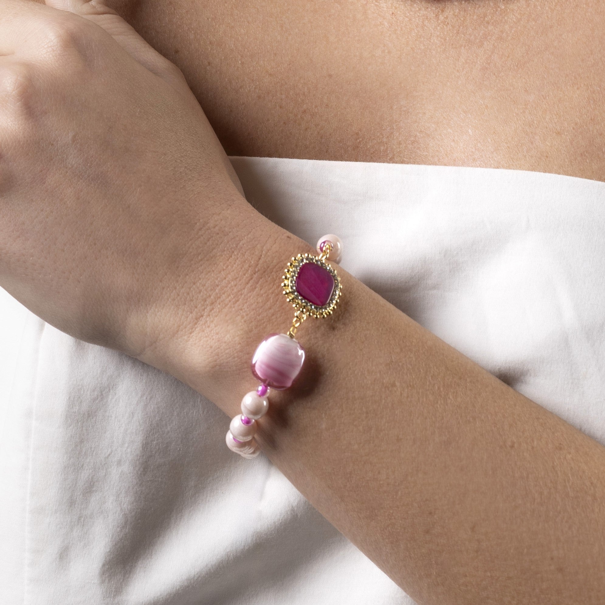 Bloom Murano glass bracelet with Carnelian, Agate or Amazonite stones and brass components, 18KT Gold Finish, adjustable 7.5 inches with extension, handcrafted in Venice, Italy. on a wrist against a white background