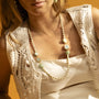 Woman wearing a Bloom Murano glass necklace with Carnelian, Agate and Amazonite stones, 18KT Gold Finish over brass, adjustable 18.5 inches with extension, handcrafted in Venice, Italy.