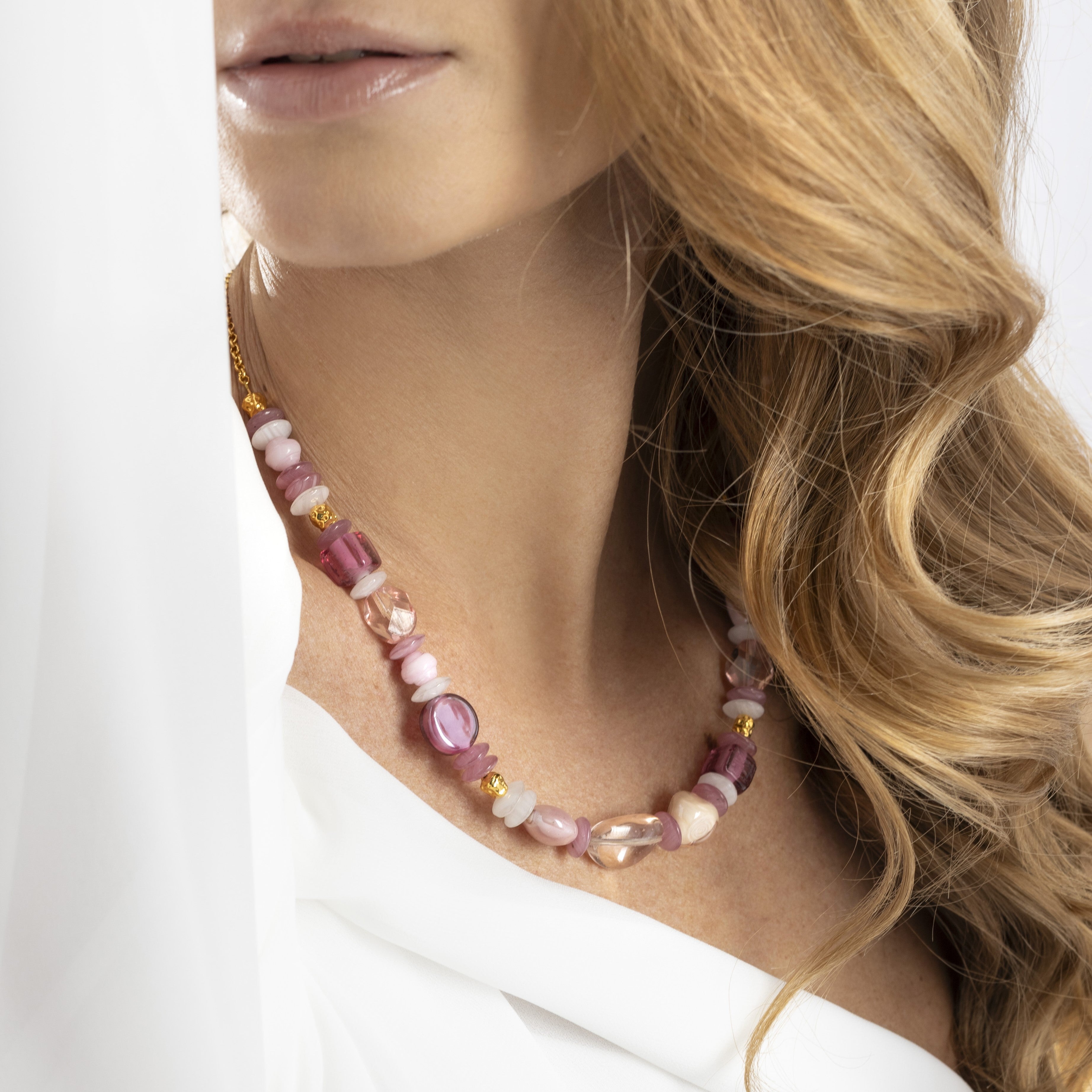 Evoque Murano glass easy choker necklace with brass elements and stainless steel components, adjustable 17.75 inches with extension, handcrafted in Venice, Italy. worn by a person with blonde hair.