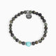 Koko Collection - Beaded bracelet with a turquoise bead and silver charm on a white background
