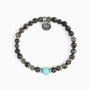 Koko Collection - Beaded bracelet with a turquoise bead and silver charm on a white background