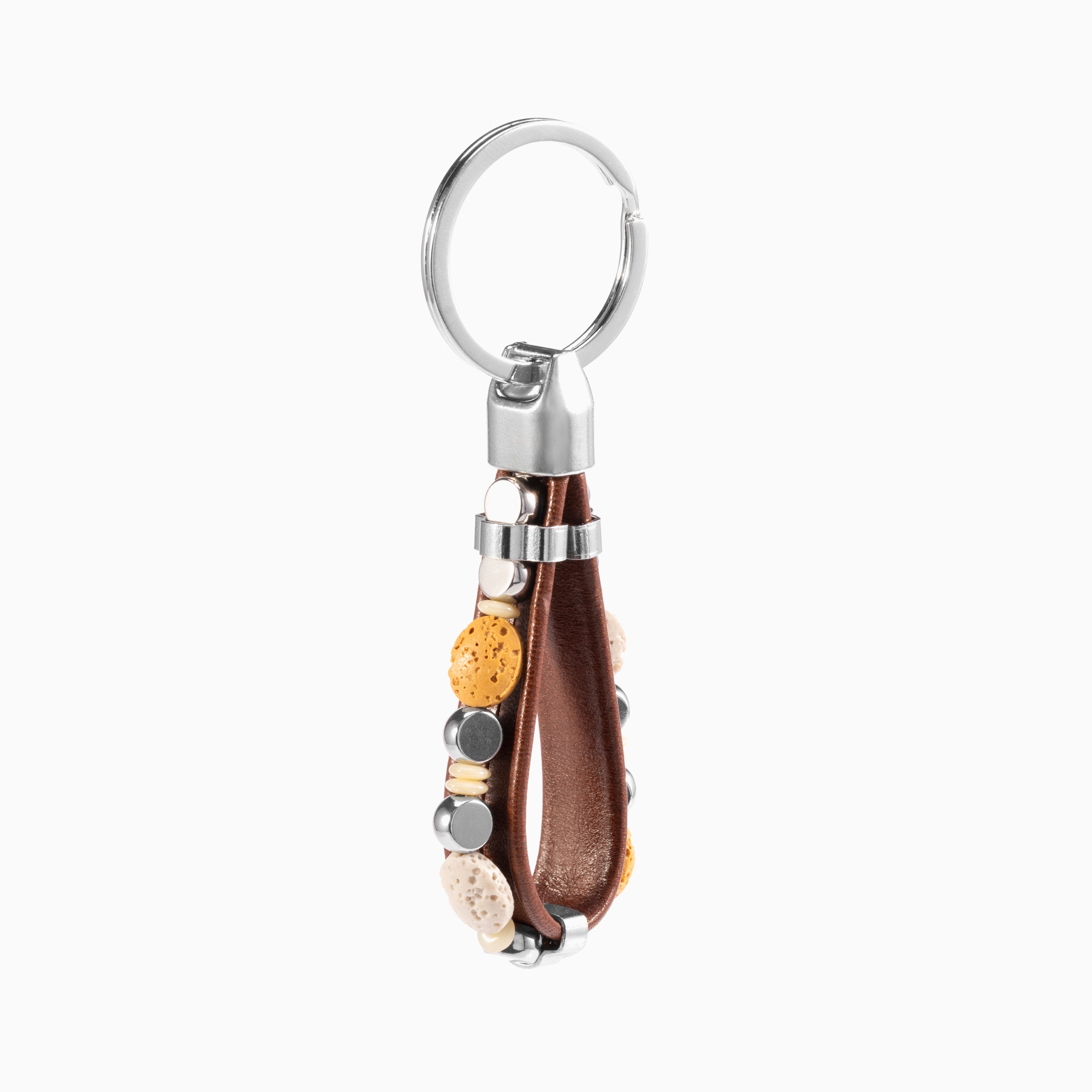 Hush Collection men's keychain with leather, lava stone, stainless steel and brass, rhodium finish, 10 cm length — detail view.