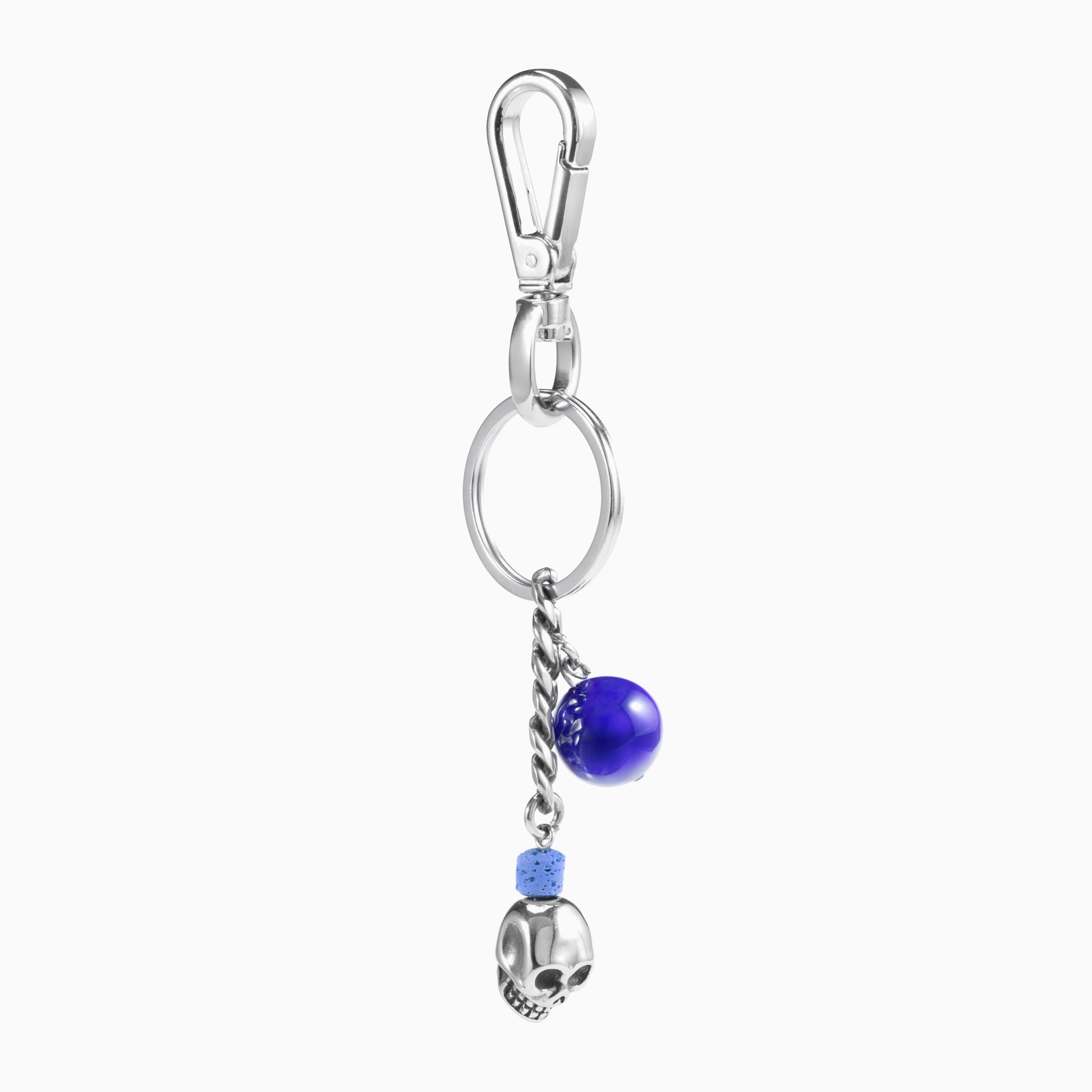 Dusk Collection men's keychain with lava stone bead, stainless steel hardware and brass accent, 13 cm length, skull detail — detail view.