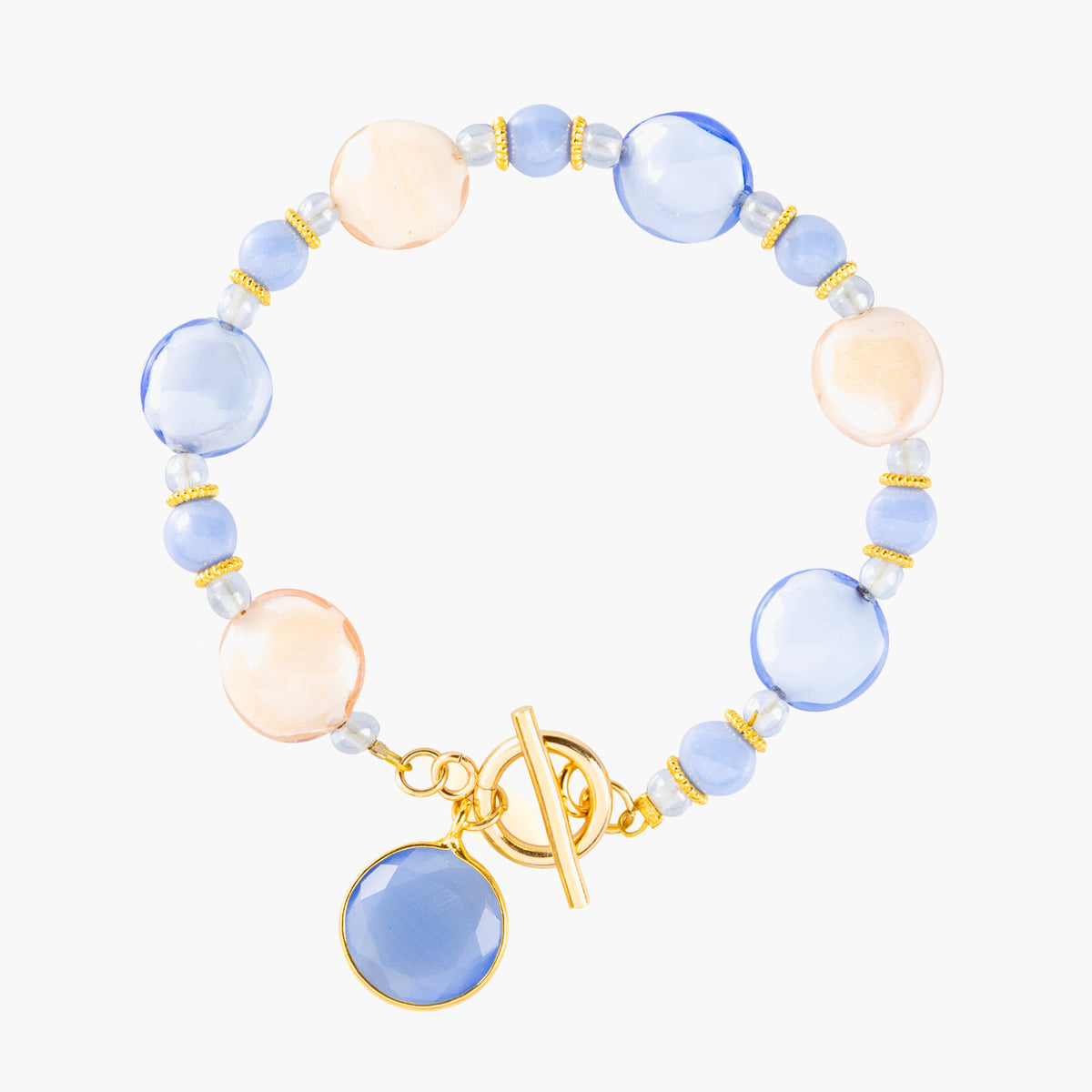 MurrinaMurano.us Trace Bracelet featuring soft blue Murano Glass beads, peach and clear accents, gold-finished details, and a matching blue glass pendant. Handcrafted in Italy.