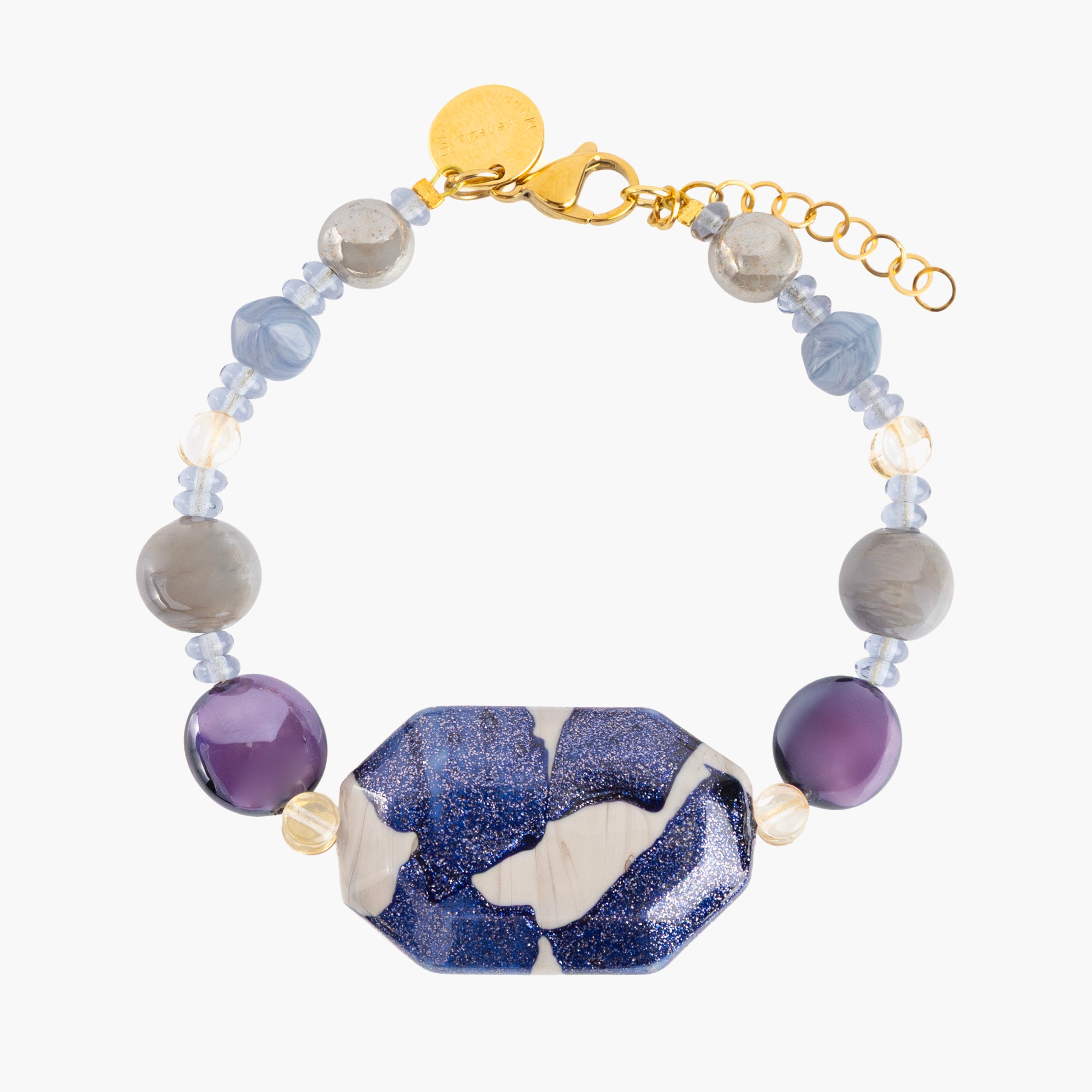 MurrinaMurano.us Frame Bracelet in blue Murano Glass, featuring faceted purple accents, sculptural metal details, and a distinctive blue-and-white centerpiece. Handcrafted in Italy.