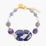 MurrinaMurano.us Frame Bracelet in blue Murano Glass, featuring faceted purple accents, sculptural metal details, and a distinctive blue-and-white centerpiece. Handcrafted in Italy.