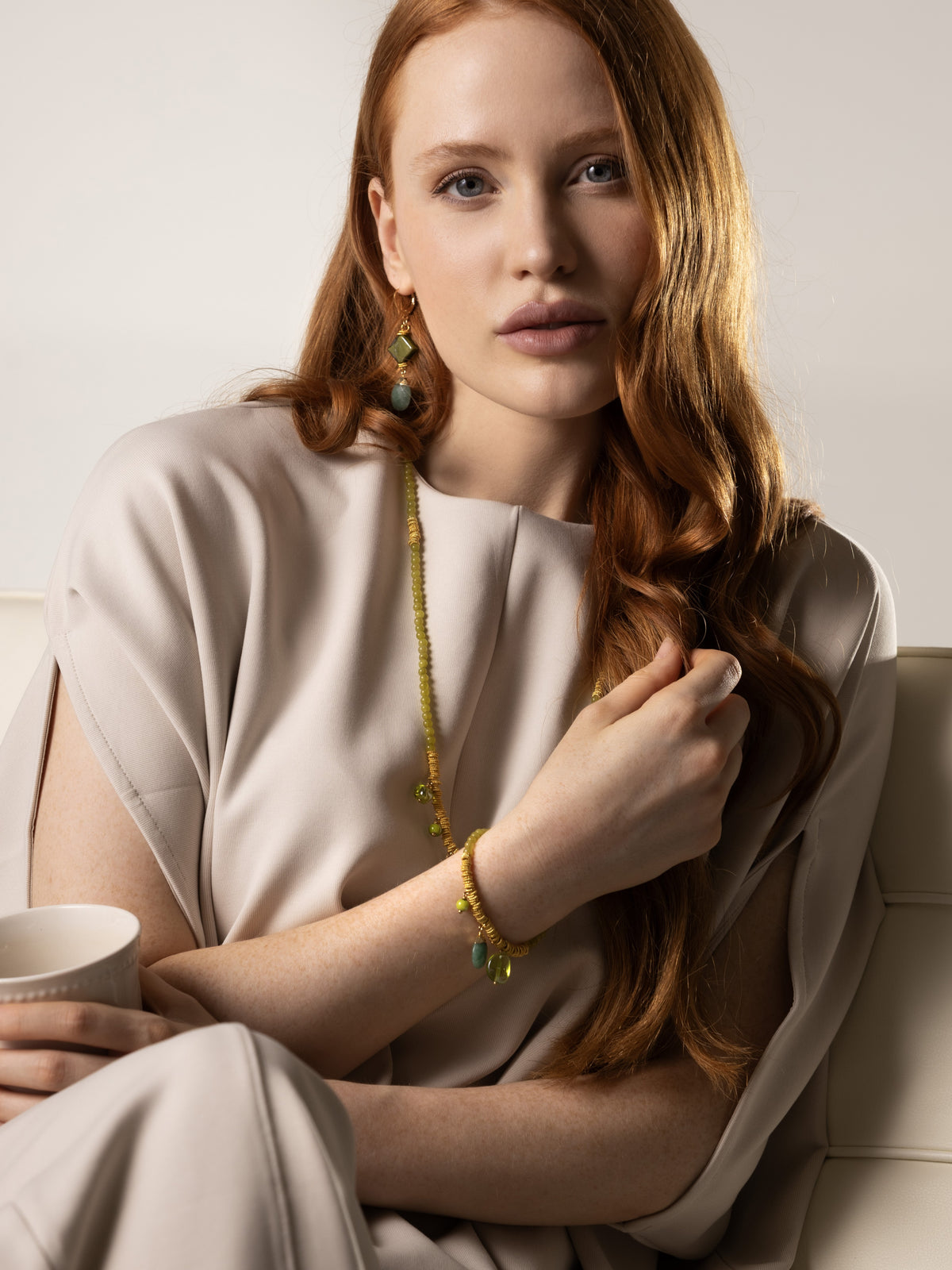 MurrinaMurano.us green Murano Glass Veil Bracelet with 18KT gold-finished details, shown worn on the wrist. 