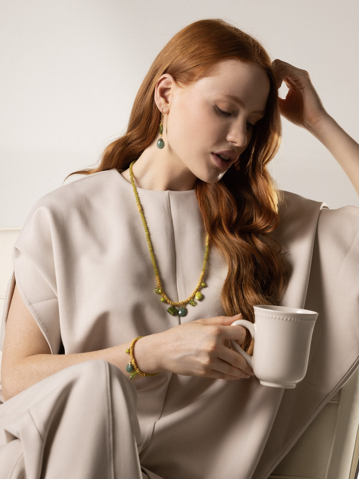 MurrinaMurano.us green Veil Bracelet with Murano Glass beads and 18KT gold-finished details, styled on the wrist. Handcrafted in Italy.