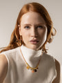 MurrinaMurano.us pink and orange Murano Glass Veil Choker Necklace with 18KT gold-finished details, modeled at the neckline. Handcrafted in Italy.