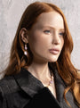 MurrinaMurano.us model wearing Trace Drop Earrings in pink Murano Glass, styled as elegant three-part drops with faceted glass pendants. Handcrafted in Italy.