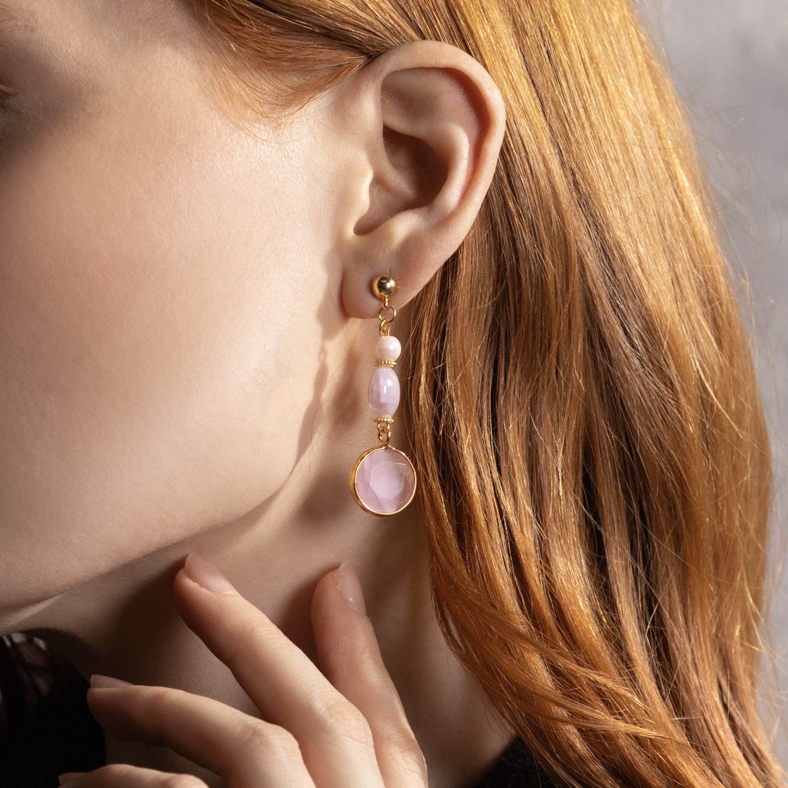 MurrinaMurano.us model wearing pink Trace Drop Earrings, featuring layered Murano Glass elements and faceted pink glass pendants with gold-finished detailing. Handcrafted in Italy.