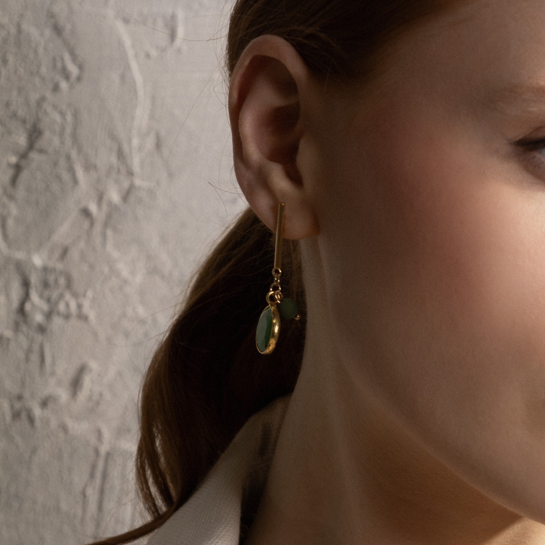 MurrinaMurano.us close-up of Trace Easy Drop Earrings in green Murano Glass, showing the faceted pendant, rounded glass accent, and 18KT gold-finished details. Handcrafted in Italy.