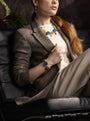 Woman wearing an Edge Murano glass bracelet with topaz-colored glass elements, 18KT Gold Finish over brass, handcrafted in Italy.