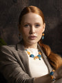 Woman wearing Edge Murano glass drop earrings with blue and orange glass elements, 18KT Gold Finish over brass, handcrafted in Italy.