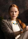 Woman wearing an Edge Choker Necklace with blue and orange Murano glass elements, 18KT Gold Finish over brass, handcrafted in Italy.
