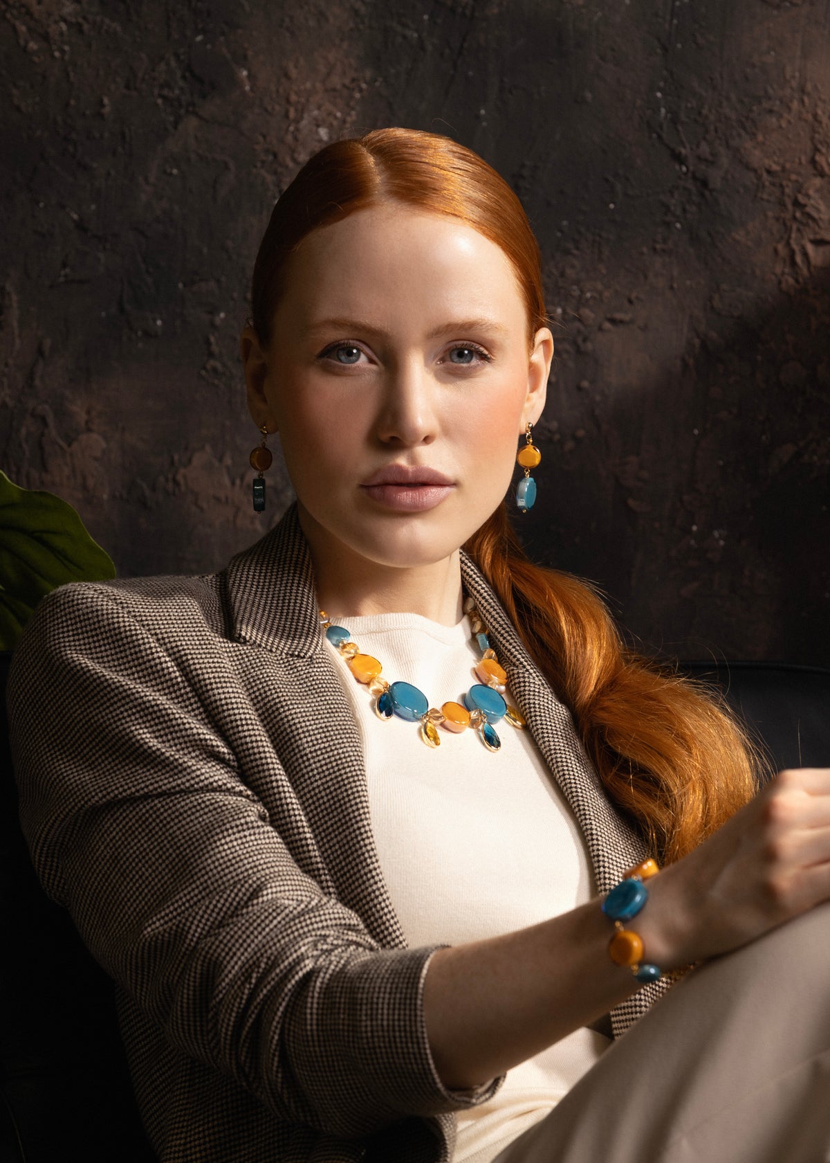 Woman wearing an Edge Choker Necklace with blue and orange Murano glass elements, 18KT Gold Finish over brass, handcrafted in Italy.