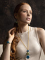 MurrinaMurano.us Edge drop earrings featuring blue and green Murano glass elements, 18KT Gold Finish over brass, worn with matching Italian artisan jewelry.