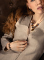 MurrinaMurano.us model wearing the Core Link Bracelet in brown and gray Murano Glass, styled with 18KT gold-finished details. Handcrafted in Italy.