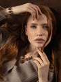 MurrinaMurano.us model wearing a Core Link Bracelet in brown and gray Murano Glass with 18KT gold-finished details. Handcrafted in Italy.