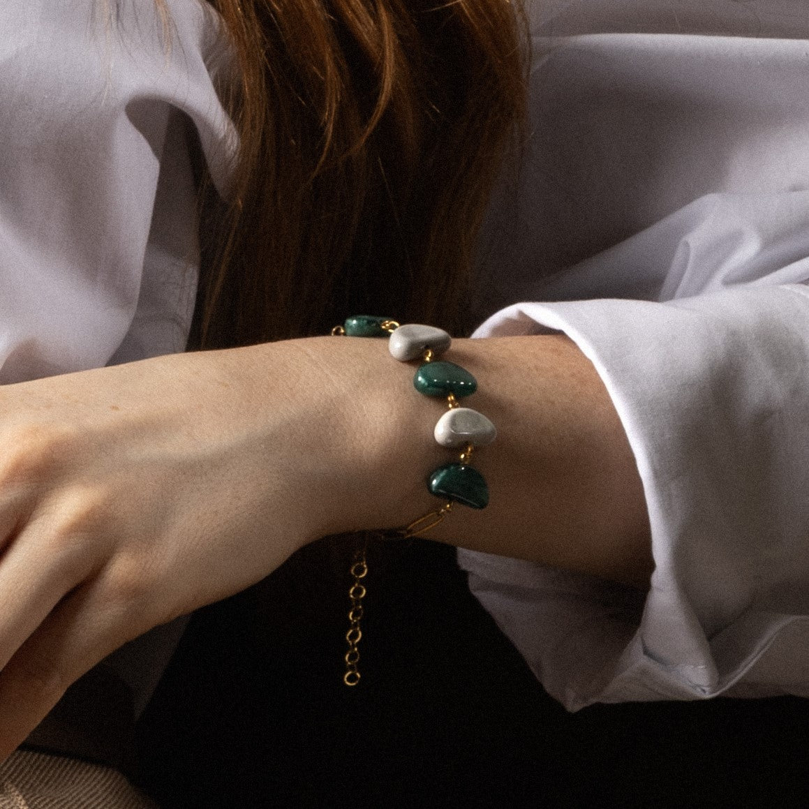 Core Link Bracelet in green Murano Glass with 18KT gold-finished details, worn on a model's wrist. Handcrafted in Italy.