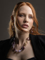 MurrinaMurano.us model wearing the pink Frame Choker Necklace with luminous pink and lilac Murano Glass beads and sculptural gold-finished link details. Handcrafted in Italy.