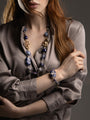 MurrinaMurano.us blue Frame Bracelet styled on the wrist, featuring luminous blue glass beads and a bold faceted centerpiece with white and blue detailing. Handcrafted in Italy.
