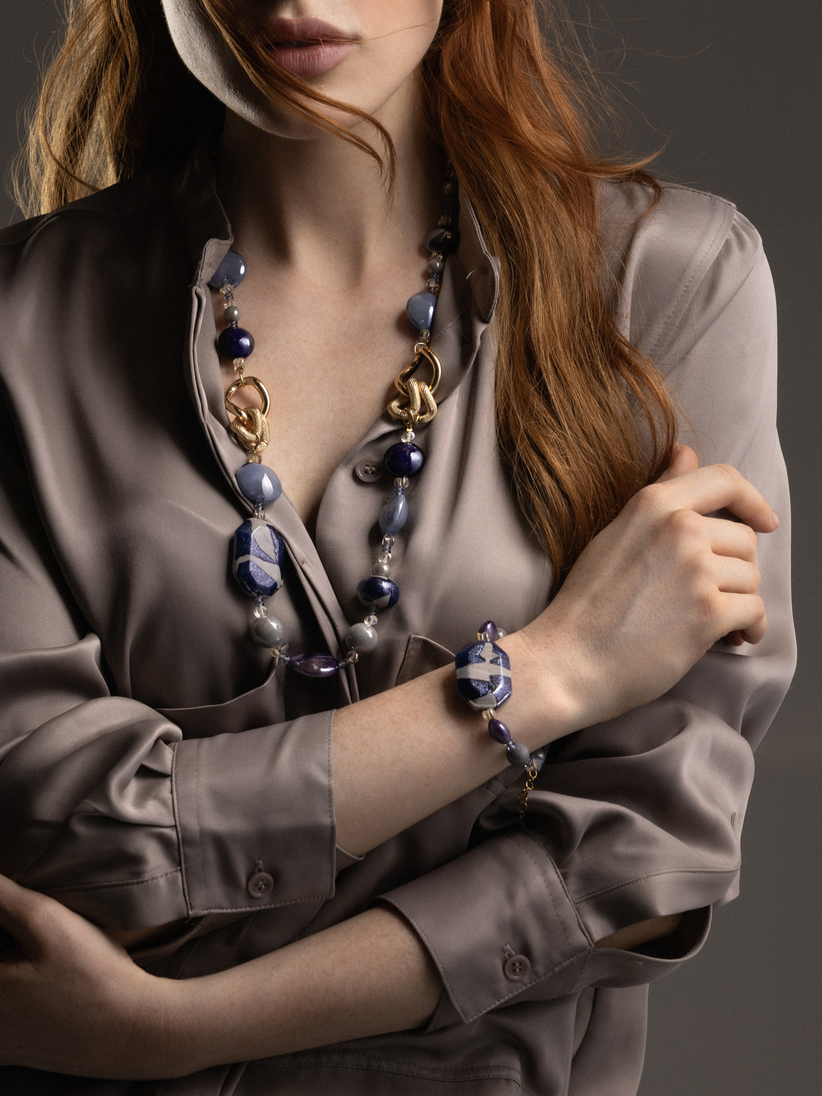 MurrinaMurano.us blue Frame Bracelet styled on the wrist, featuring luminous blue glass beads and a bold faceted centerpiece with white and blue detailing. Handcrafted in Italy.