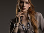 Model wearing the Frame Bracelet in cool blue Murano Glass with purple accents and sculptural gold-finished elements, shown against a dark outfit. Handcrafted in Italy.