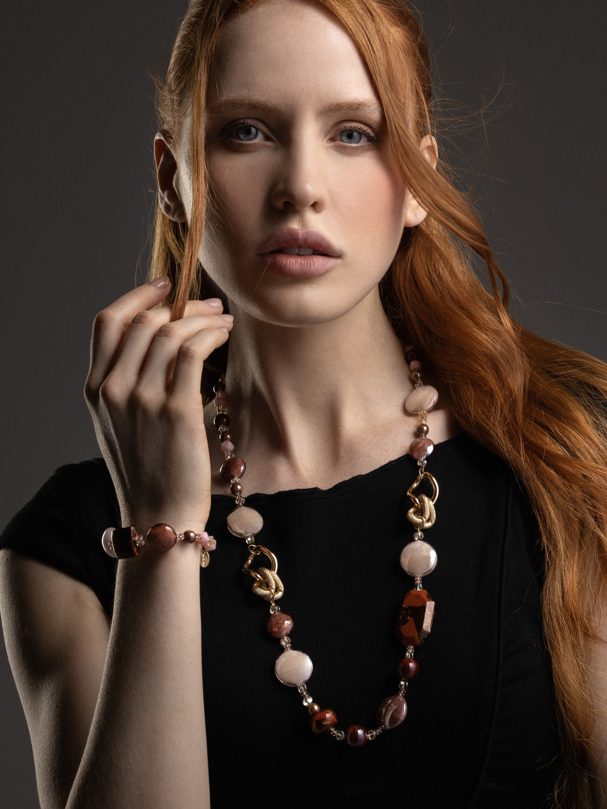 MurrinaMurano.us brown Easy Bracelet styled on the wrist, featuring rounded Murano Glass beads in warm earthy tones and a distinctive geometric centerpiece. Handcrafted in Italy.