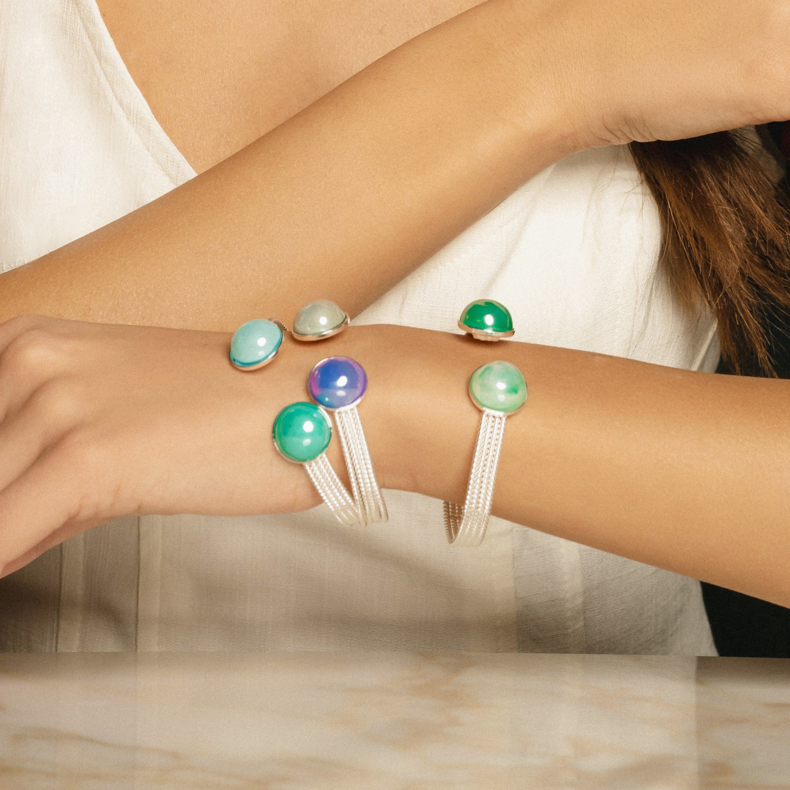 Model wearing MURRINAMURANO Venezia Bracelets from the Drop Collection, handcrafted in Original Murano glass,  Rhodium finish over Brass. Made in Italy – murrinamurano.us